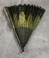 Folding fan of black carved wood with gold-green mesh trimmed with black silk