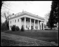 Honeyman Home, Portland. Wooden house with six columns in front. Yard in foreground.