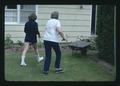 Alice Henderson and another walking to wheelbarrow, Corvallis, May, Oregon, 1975