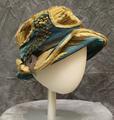 Hat of cerulean blue silk velvet with high crushed crown and asymmetrical brim