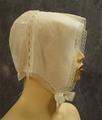 Nightcap of white cotton batiste with tape lace insertion connecting crown and brim