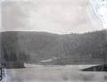 Train along far bank of a river (Columbia River?)