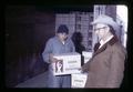 Person loading Encore french fries into truck and Julius Binder, Metolius, Oregon, February 1972