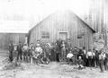 Loggers in front of logging camp building