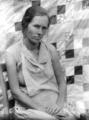 Woman in front of block quilt