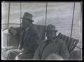 Two unidentified men on a boat