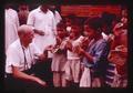 Jim Howard with kids eating chapatis, India, 1979