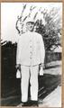 Boy dressed in white ready to deliver milk from Geo. Reed's