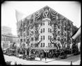 Henry Building at 4th and Oak, Portland, decorated with flags and bunting for Elks Convention. Auto and people on street.