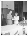 Irene Carl receives a radio gift from Ralph Floberg