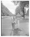 Earl Heckert posing on campus next to a stop sign.