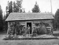 Headquarters of the coyote proof pasture showing J. R. Carper, USFS hunter and trapper, with skins of predatory animals killed by him, Wallowa National Forest