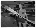 A member of the Beaver crew team posing with an oar