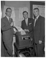 Sigma Delta Chi (journalism honorary) members posing with an Associated Press ticker, Spring 1961