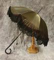 Parasol of black silk satin trimmed at the outer edge with heavy tulle floral lace