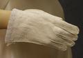 Gloves of white suede jersey with opaque white bead design at wrists