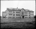 Richmond School, Portland, with school yard and field in foreground.