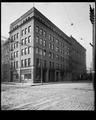 Equitable Savings & Loan Building at corner of Stark and 6th, Portland. Brick street in foreground. Power lines above.