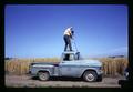 Robert W. Henderson taking photograph from top of truck, Oregon, circa 1972