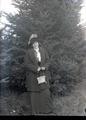 Woman standing in front of a fir tree