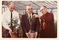 Roy Young with colleagues in greenhouse