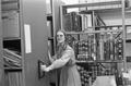 Woman standing at movable shelving