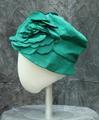 Hat of green taffeta with two large green floral designs at front