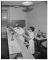 Home Economics students working in a food science laboratory, March 1957