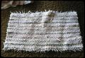 19 x 29 inch white rag rug made in 1974 on a four harness loom using old bedspreads