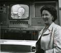 An unidentified woman in front of a television studio monitor showing UPI Chief Frank Bartholomew, 1960