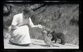 Irene Finley feeding a bear cub and cougar kitten