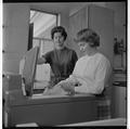 Home Economics students working with a washing machine, February 1964