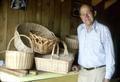 Mr. Geisler with pile of finished baskets