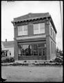 Carlton State and Savings Bank building, Carlton, OR. Reflections in bank windows, house in background.