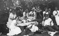 Picnickers enjoying food and drink, including Weinhard beer