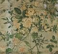 Textile fragment of ecru satin brocaded with a large floral design in greens, corals and golden yellows