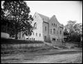 First Congregational Church, Hood River. Stone building on hill above foreground street. Tree beside church.