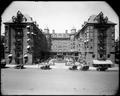 Elevated front view, Portland Hotel. Autos on 6th St. in foreground. Landscaped driveway into hotel.