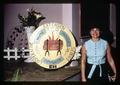 Curry County, Oregon Home Economics Extension agent Jane Shearer posing with Cooperative Extension Service display, May 1970