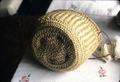 Basket of flattened straw made when she was a young girl in Merrill around 1937
