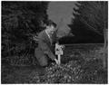 Don Martel, Head of Landscape Architecture, placed identification tags on shrubs on campus, March 1958