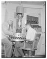 Dean Francois Gilfillan supervises electron microscope, 1956
