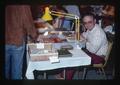 Dave Rogers at bourse table, Oregon, March 1979
