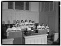 Junior girls at the First Christian church enjoy their singing under the direction of Pat Powell at the organ console, December 1950