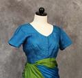 Blouse of bright teal silk with soft-V neckline and short sleeves