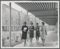 Female students walking near West Hall dormitory.