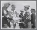 August L. Strand presenting certificate to USMC Cadet, circa 1951