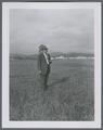 Harry Schoth standing on the original plot of alta tall fescue, 1950