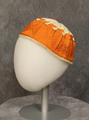 Cap of white cotton with trim of orange solid embroidery in a textural geometric pattern