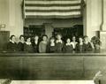 Library staff standing behind desk, 1921